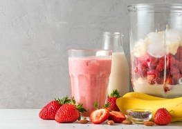 Fruit smoothie next to other ingredients