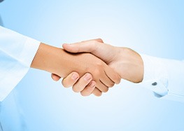 Close-up of dentist and patient shaking hands
