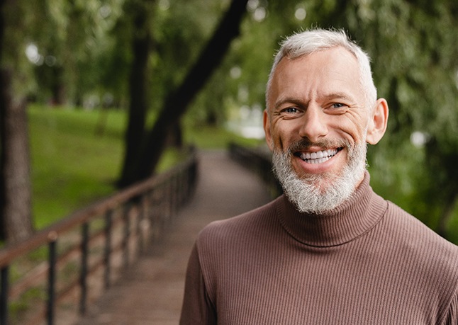 man smiling with a dental bridge in Rome