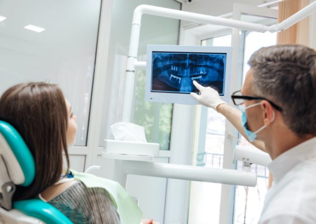 Dentist and patient looking at digital imaging on chairside computer