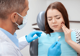 Woman with toothache visiting her emergency dentist in Rome, GA