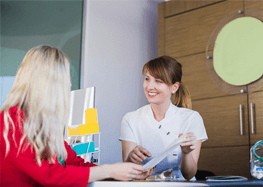 Woman learning about her options for paying for emergency dentistry