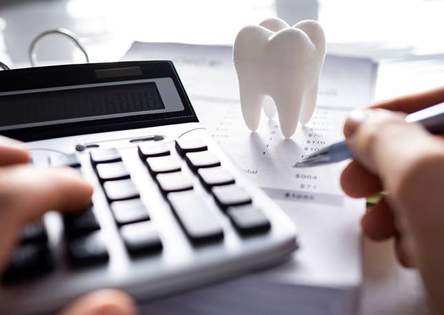 A patient calculating the cost of dental crowns