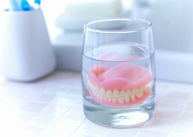 dentures in glass of water