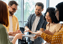 a man with dentures speaking with his colleagues