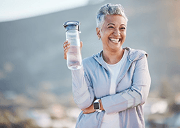 a woman with dentures enjoying her healthy smile