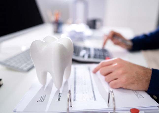 patient calculating cost of dentures in Rome