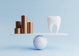 Coins balanced against tooth