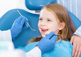 Child smiles at dentist