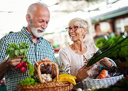 senior man and woman buying fresh produce 