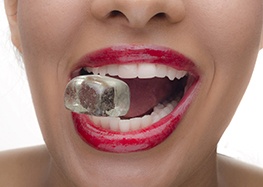 Woman holding an ice cube in her mouth