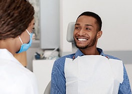 Patient smiling at his implant dentist in Rome
