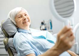 patient smiling after getting dental implants in Rome