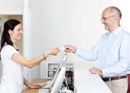 patient paying receptionist for dental implants Rome