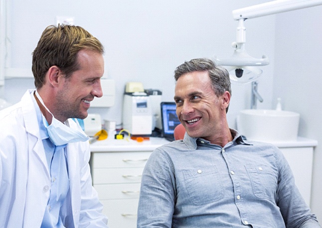 Dentist explaining dental implant post-op instructions in Rome to patient