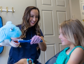 Dental team member examining patient's smile