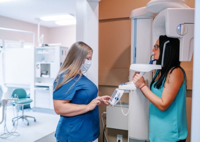 Dental team members looking at digital x-rays on computer screen