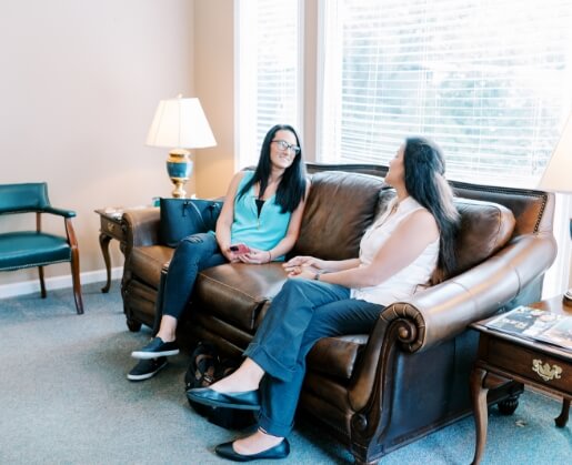 Woman in dental chair smiling at dentist