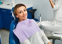 Woman smiling while sitting in treatment chair