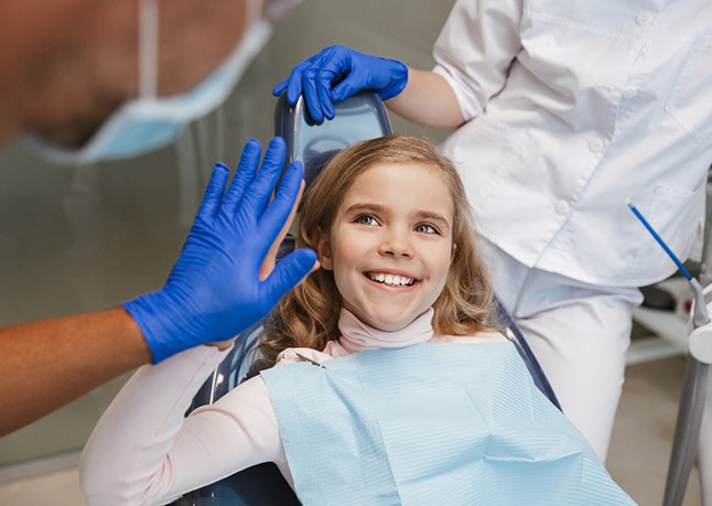 Girl high-fiving the dentist