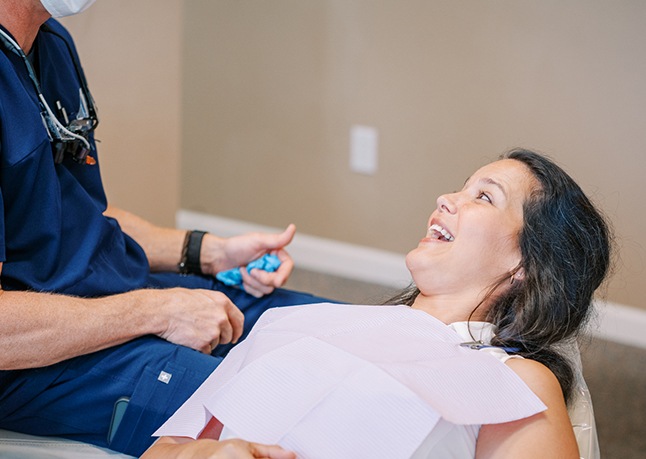 Woman smiling during preventive dentistry checkup and teeth cleaning visit