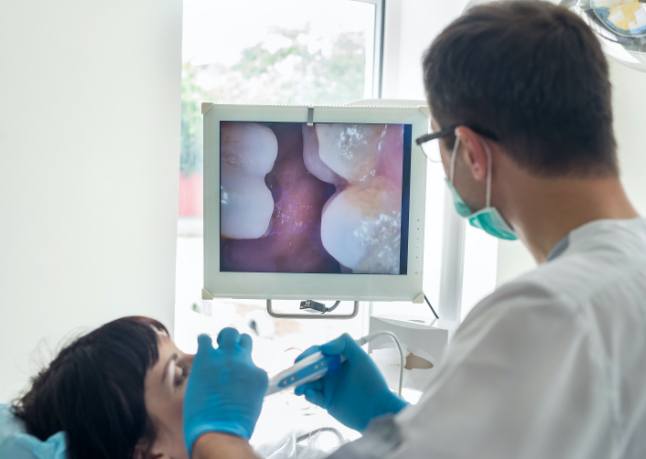 Dentist using intraoral camera to capture smile images