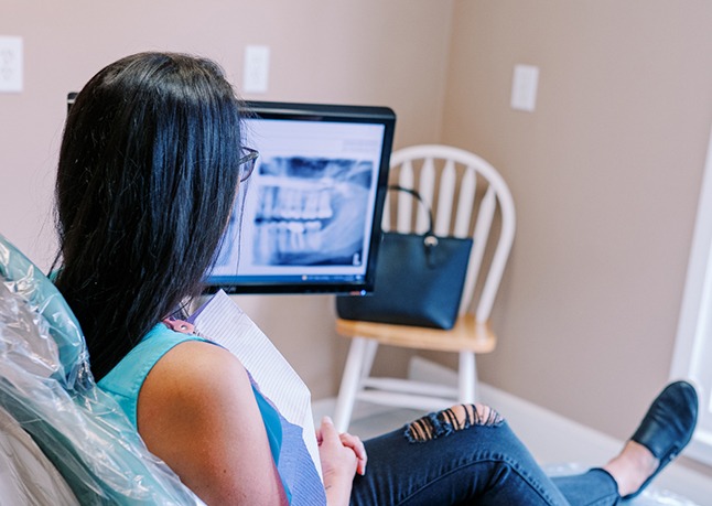 Dental team member looking at digital x-rays