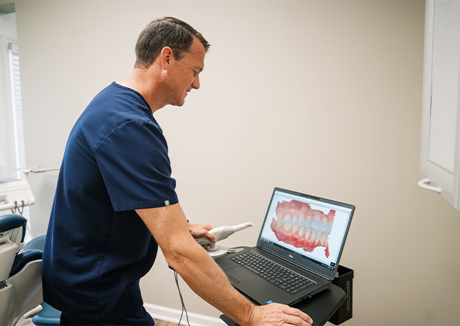 Dentist using intraoral camera to capture smile images