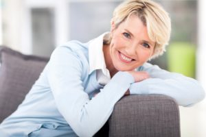 Smiling woman leaning on couch