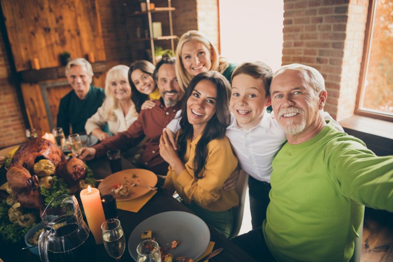 A family enjoying a holiday meal while looking out for their dental health