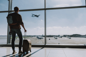 Man with suitcase standing in airport